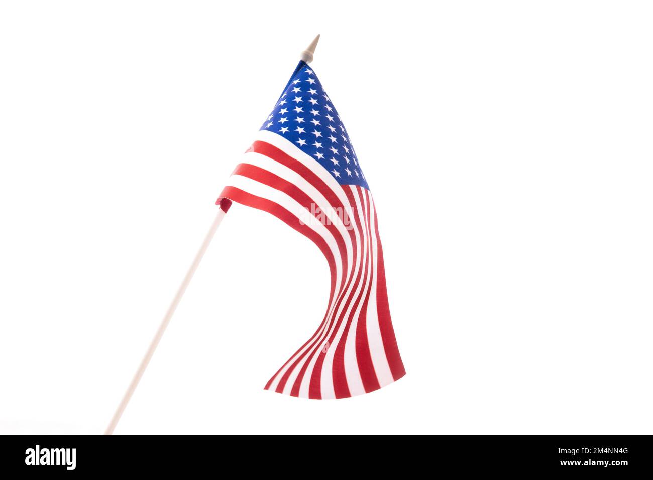 The U.S. flag is developing in the wind against a dark background. Isolate Stock Photo