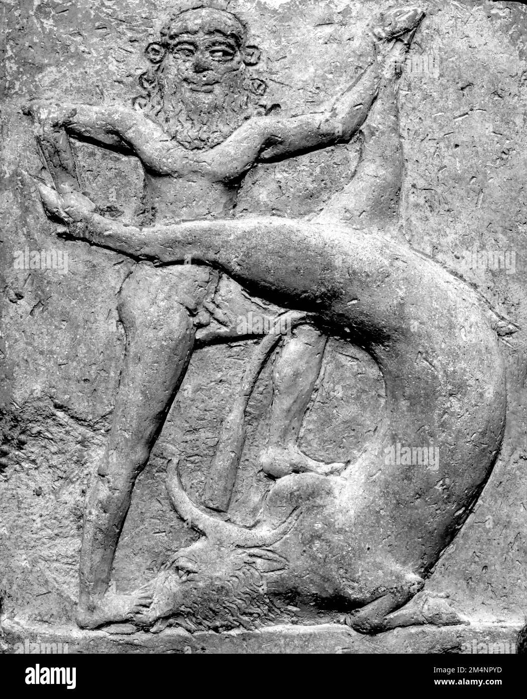 Gilgamesh. Ancient Mesopotamian terracotta relief (c. 2250-1900 BC) showing Gilgamesh slaying the Bull of Heaven, an episode described in Tablet VI of the Epic of Gilgamesh Stock Photo