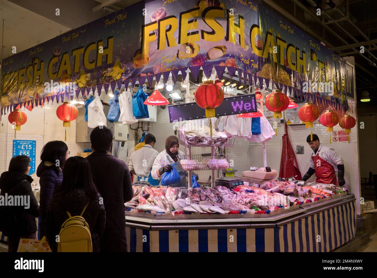 People buying meat and fish at the Bull Ring indoor markets in Birmingham,England,UK Stock Photo