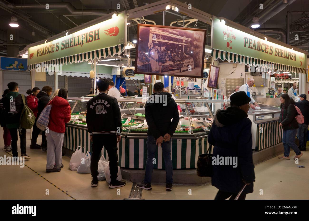People buying meat and fish at the Bull Ring indoor markets in Birmingham,England,UK Stock Photo