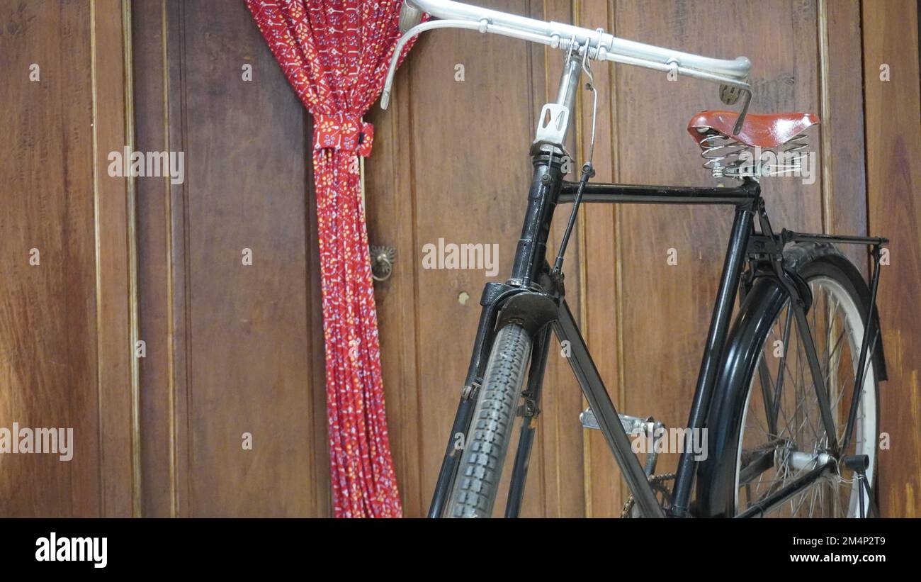 Old antique classic bicycle usually called ontel in front of the house Stock Photo