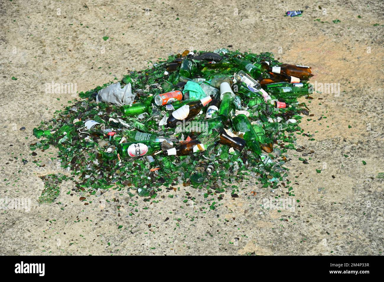 a closeup of Crushed glass bottles to recycle on concrete floor Stock