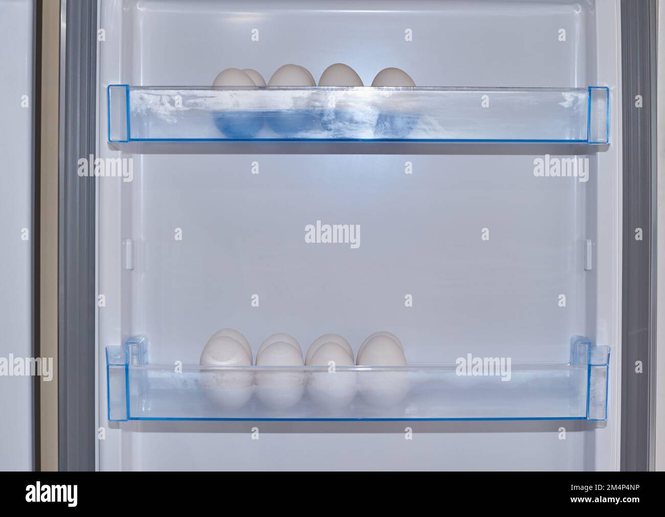 White eggs in rows in refrigerator boxes Stock Photo