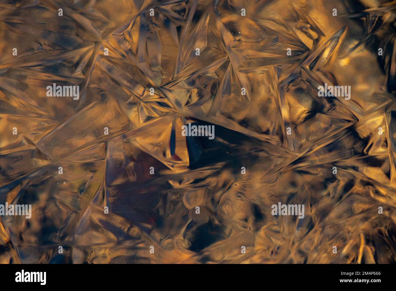 Close-up of Ice patterns captured in frozen stream in the New Forest hampshire UK. Stock Photo