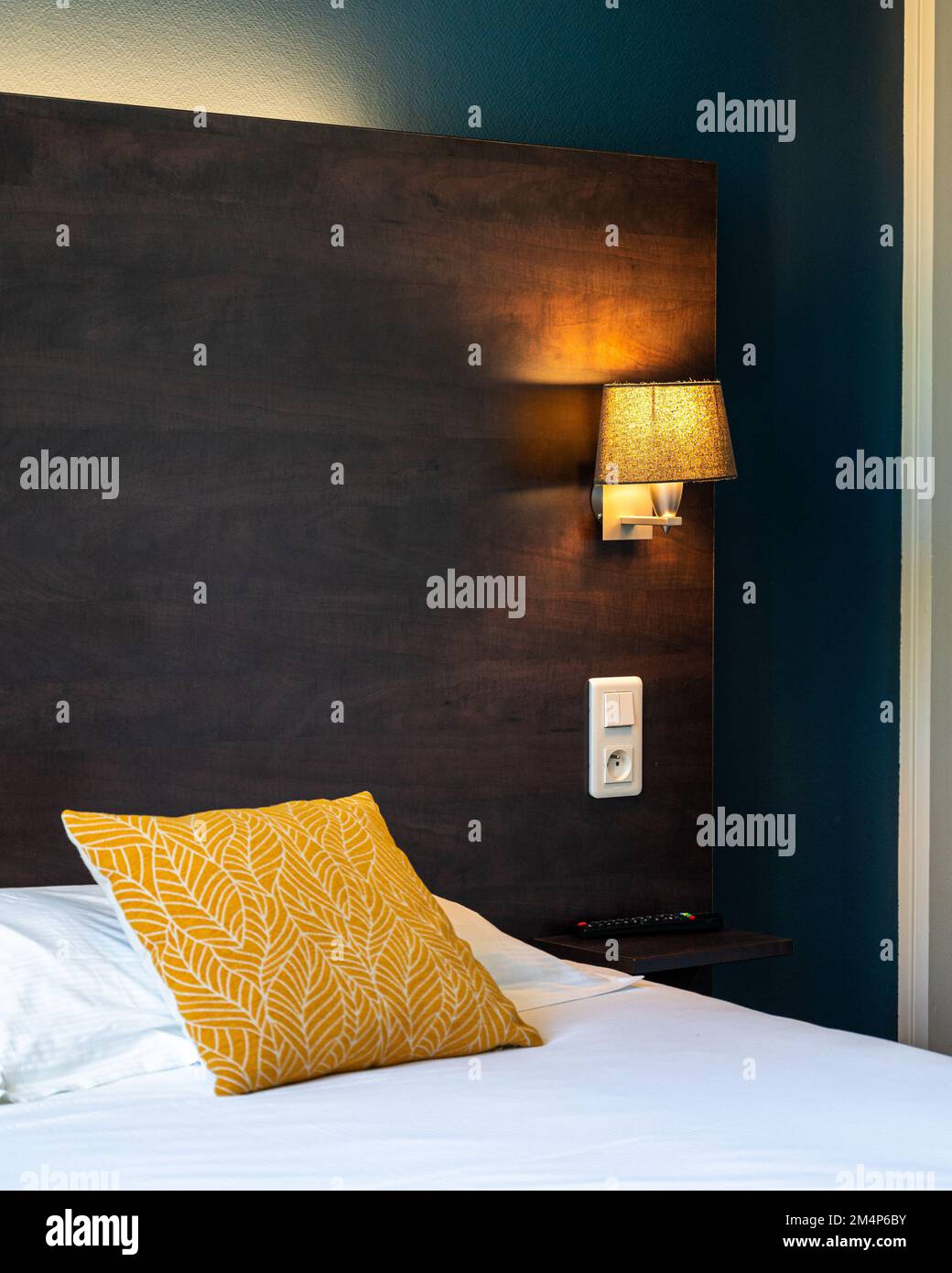 A vertical detailed view of the side lamp of a bed - bedroom design