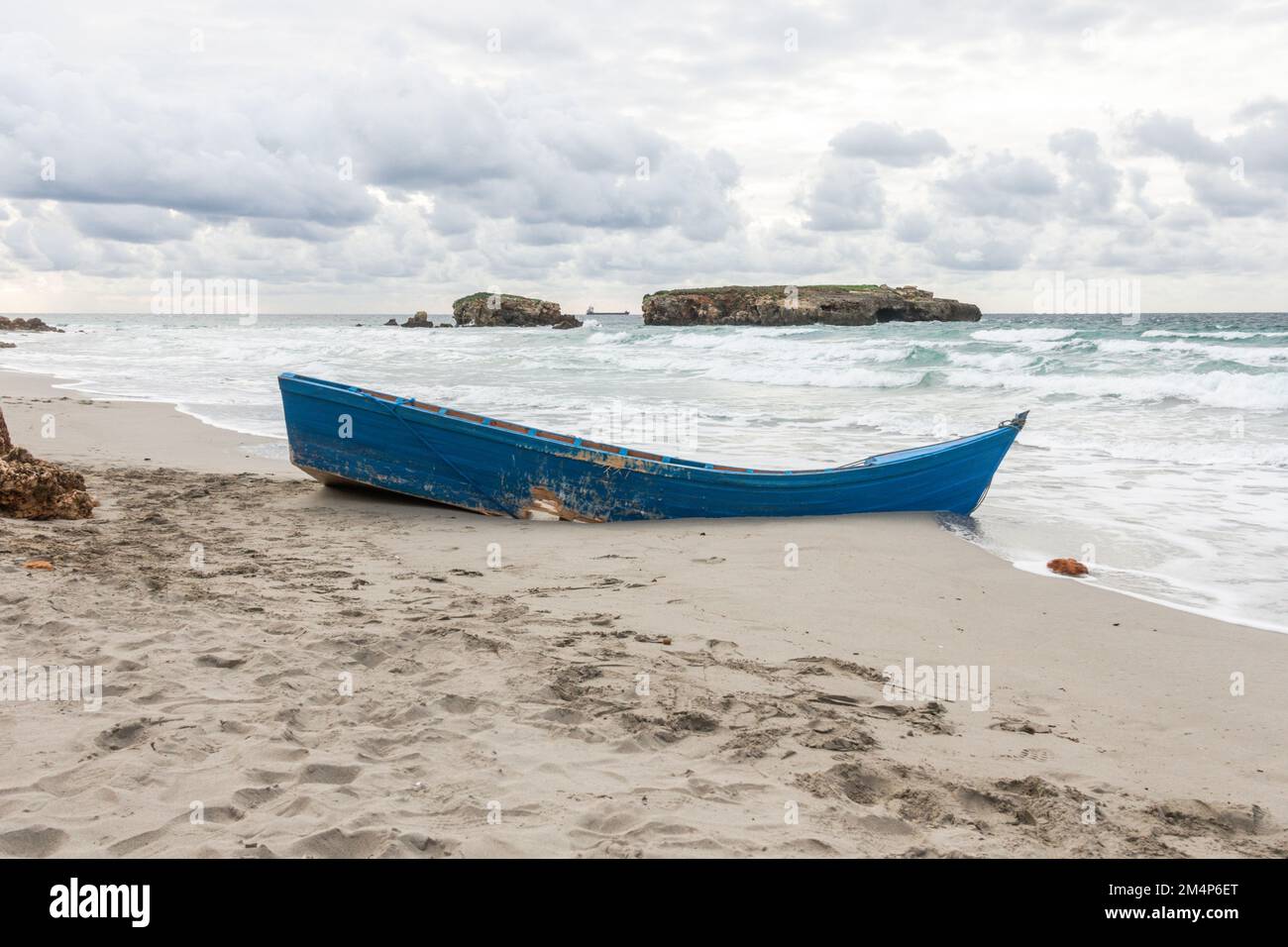 Old fishing boat stranded on beach, Bini Gaus, Menorca, Balearic islands, Spain. Stock Photo