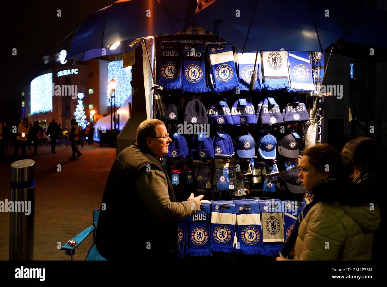 A street vendor sells merchandise outside of the stadium ahead of the UEFA Women's Champions League Group A match at Stamford Bridge, London. Picture date: Thursday December 22, 2022. Stock Photo