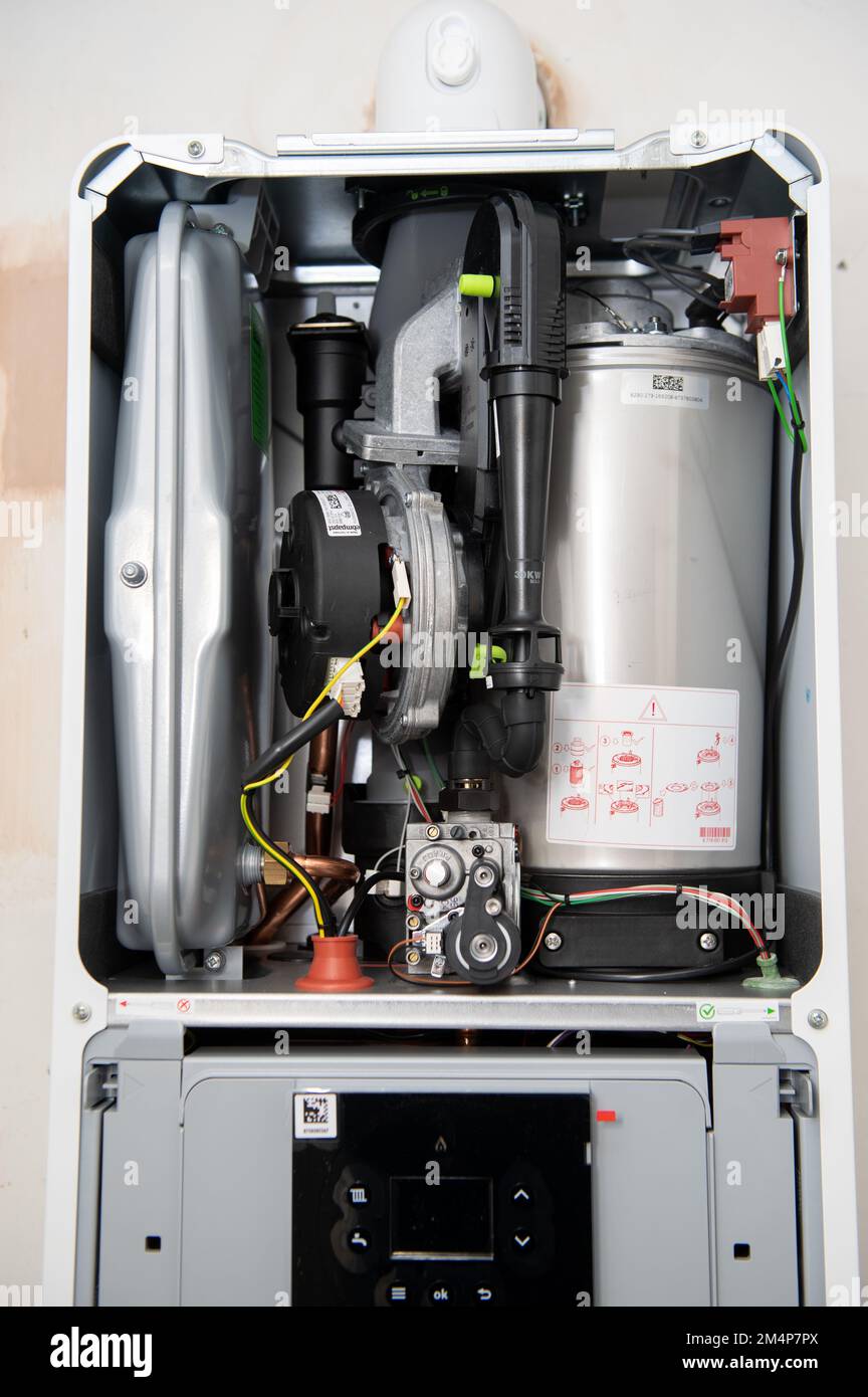 Inside of a modern touch screen Worcester Gas central heater boiler replacing an older model. Stock Photo