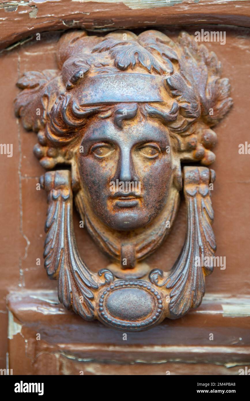old metal historical doorknob , door with female head figure Stock Photo Alamy