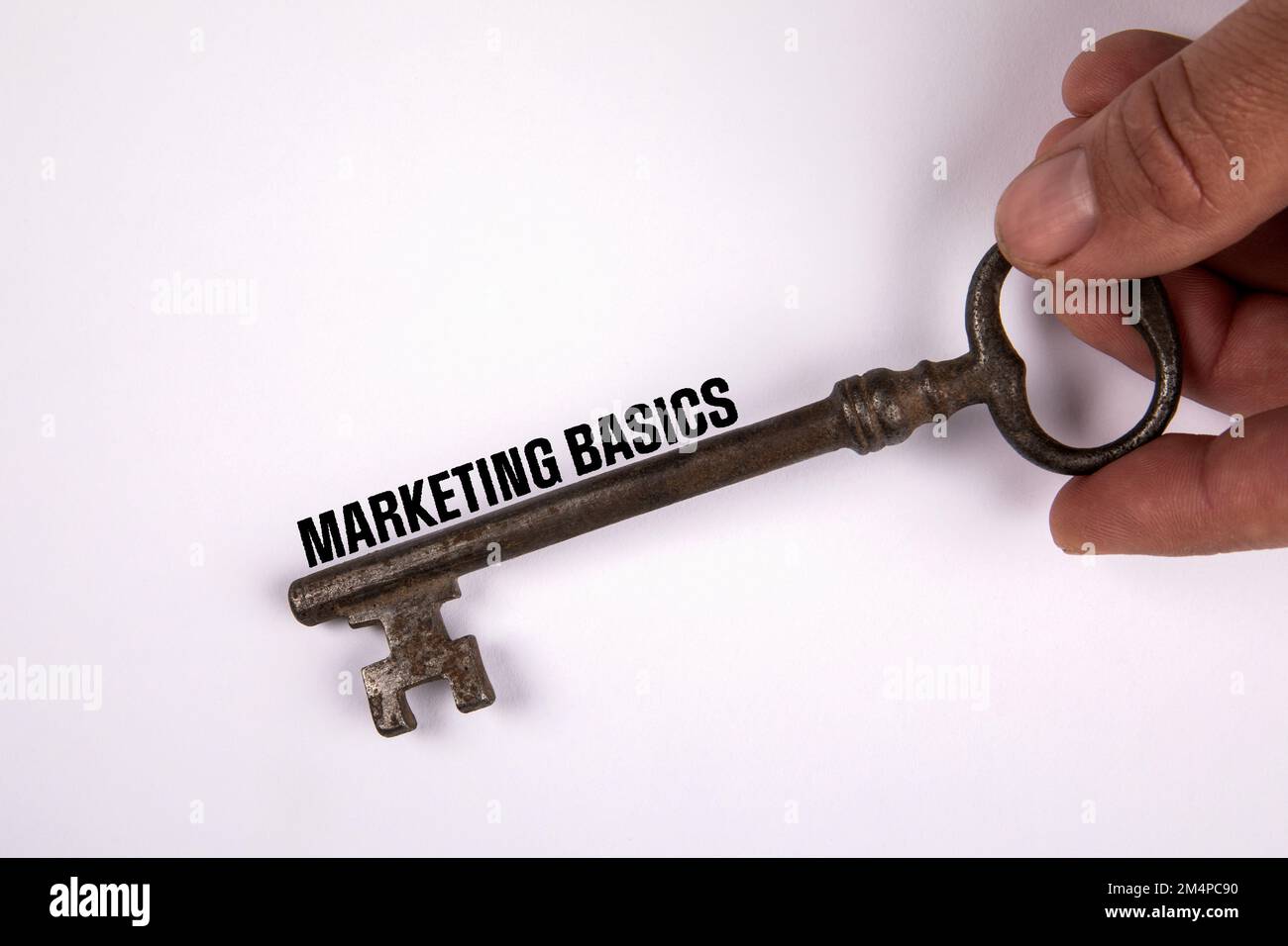Marketing Basics concept. Knowledge and learning. Old key on a white background. Stock Photo