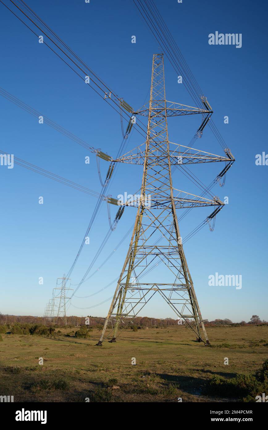Electricity pylons or Lattice Towers situated in the countryside of Plaitford Common near the New Forest Hampshire England. Stock Photo