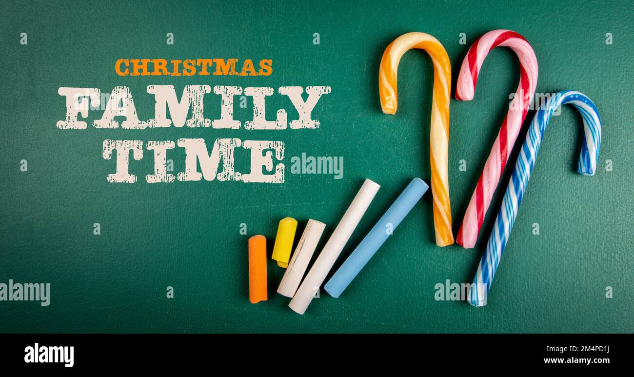 Christmas Family Time. Text and candy canes on blackboard background. Stock Photo