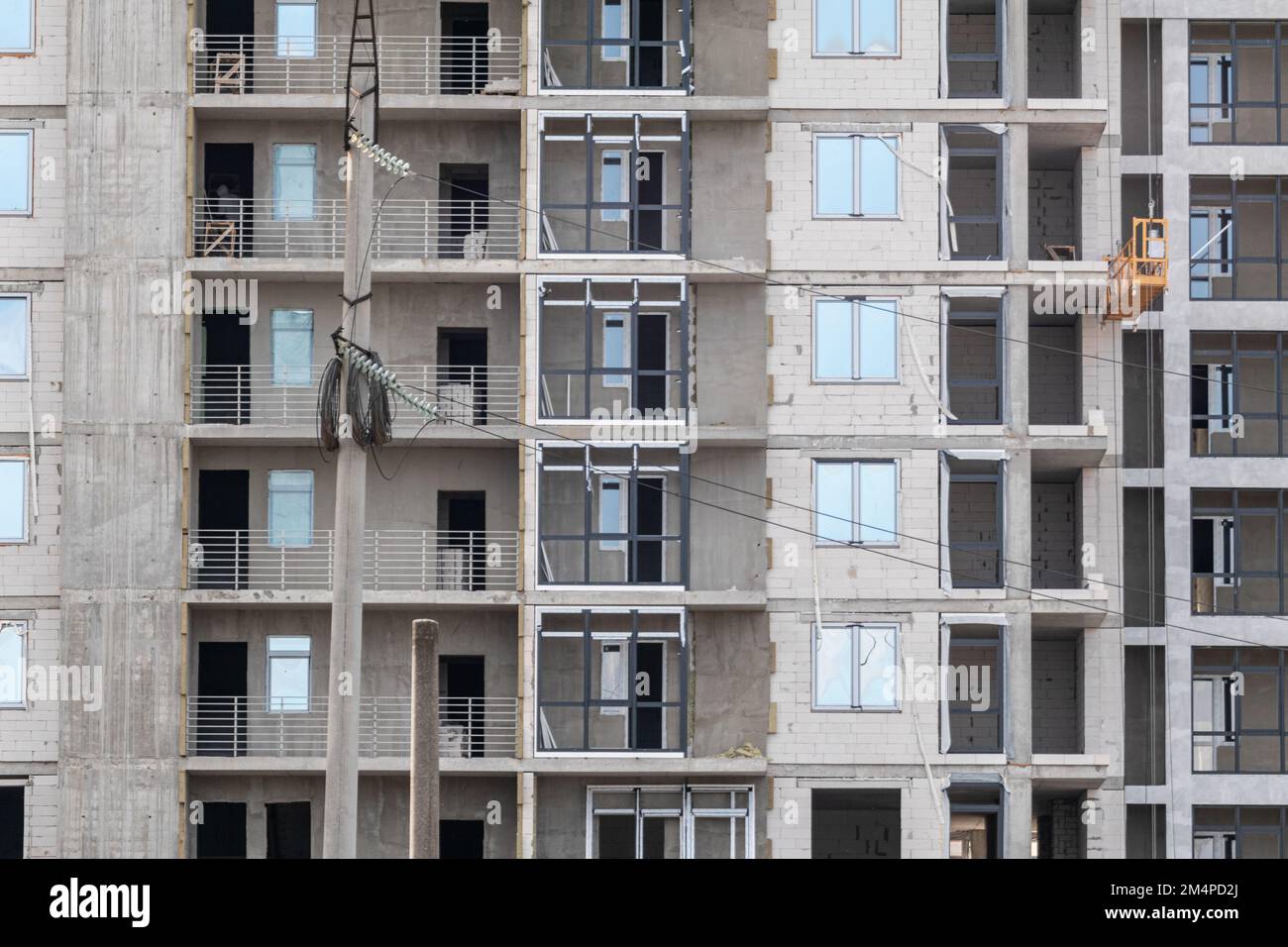 Multistory residential white brick building facade construction site, outdoor architecture details pattern Stock Photo