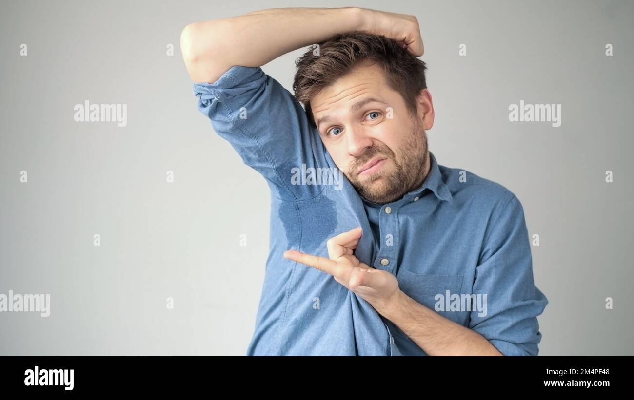 Sweaty spot on the shirt because of the heat, worries and diffidence. Man feeling embarrased
