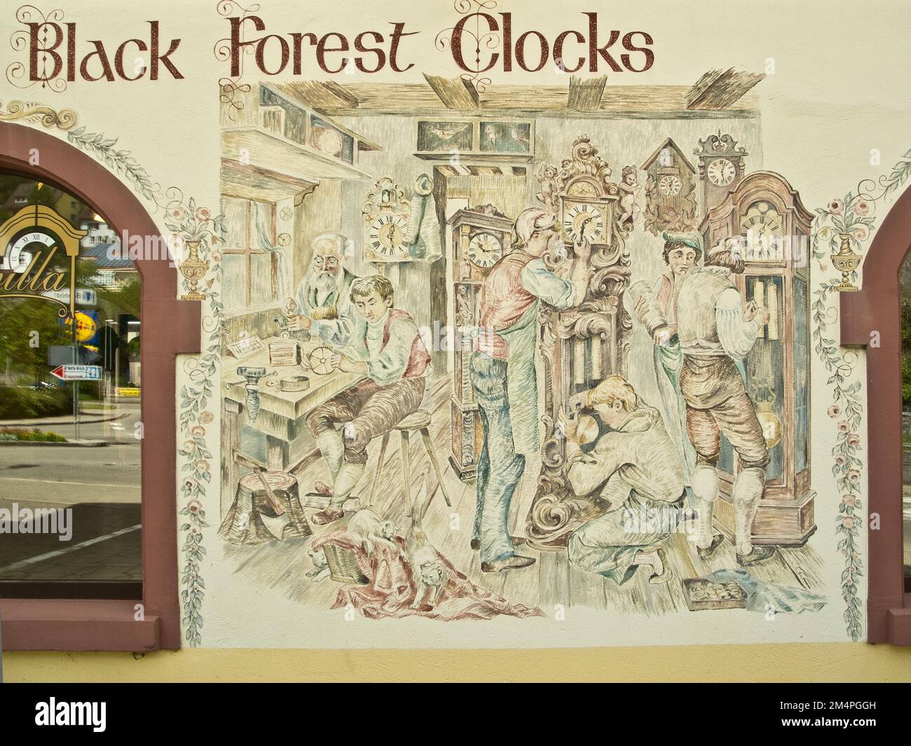 Clockmaker depicted in a facade painting of a Black Forest clock shop
