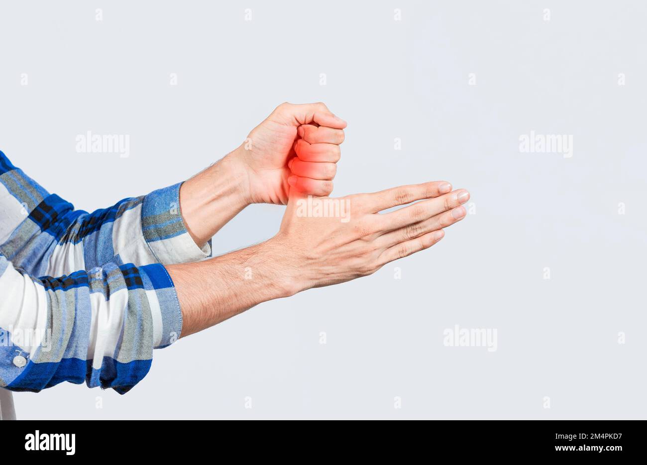 Sore fingers with arthritis isolated. Hand holding sore thumb, Close up of person hands with sore fingers, Concept of arthritis and pain in the Stock Photo