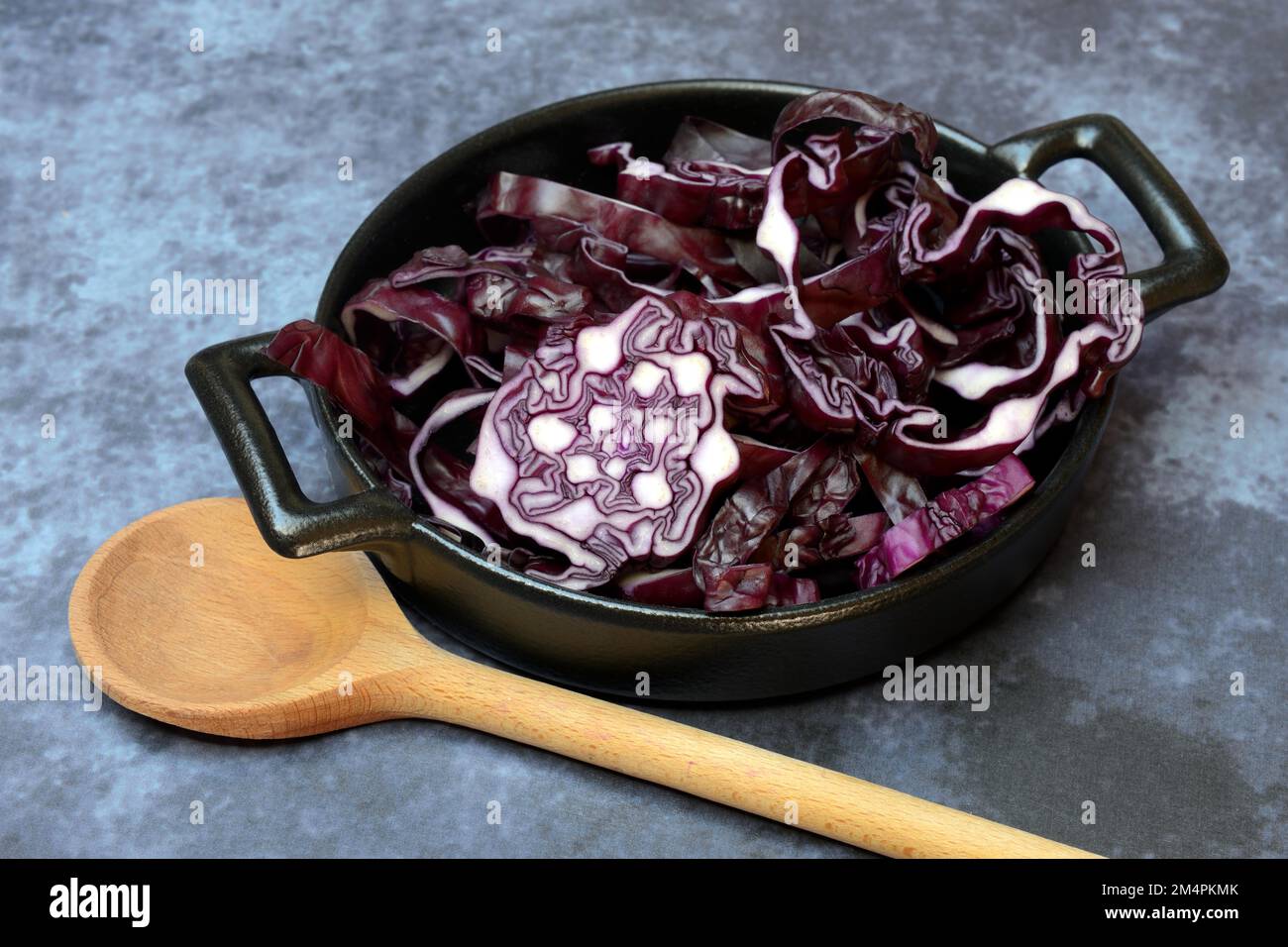 Red cabbage, cut red cabbage in pot and cooking spoon Stock Photo - Alamy