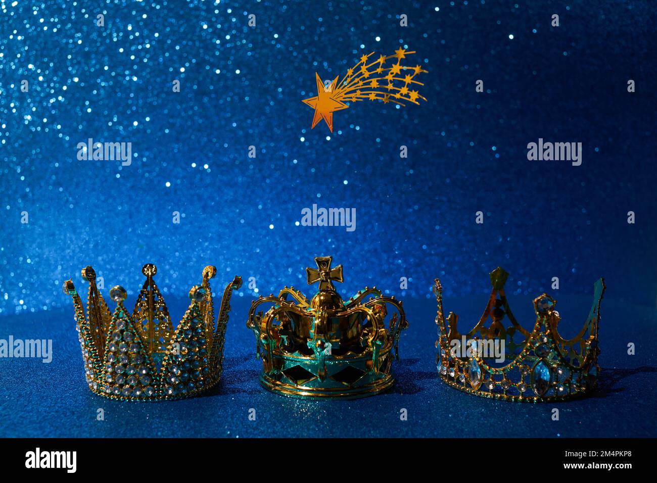 Three crowns of the three wise men with star over blue background. For Reyes Magos day and Happy Epiphany day Stock Photo