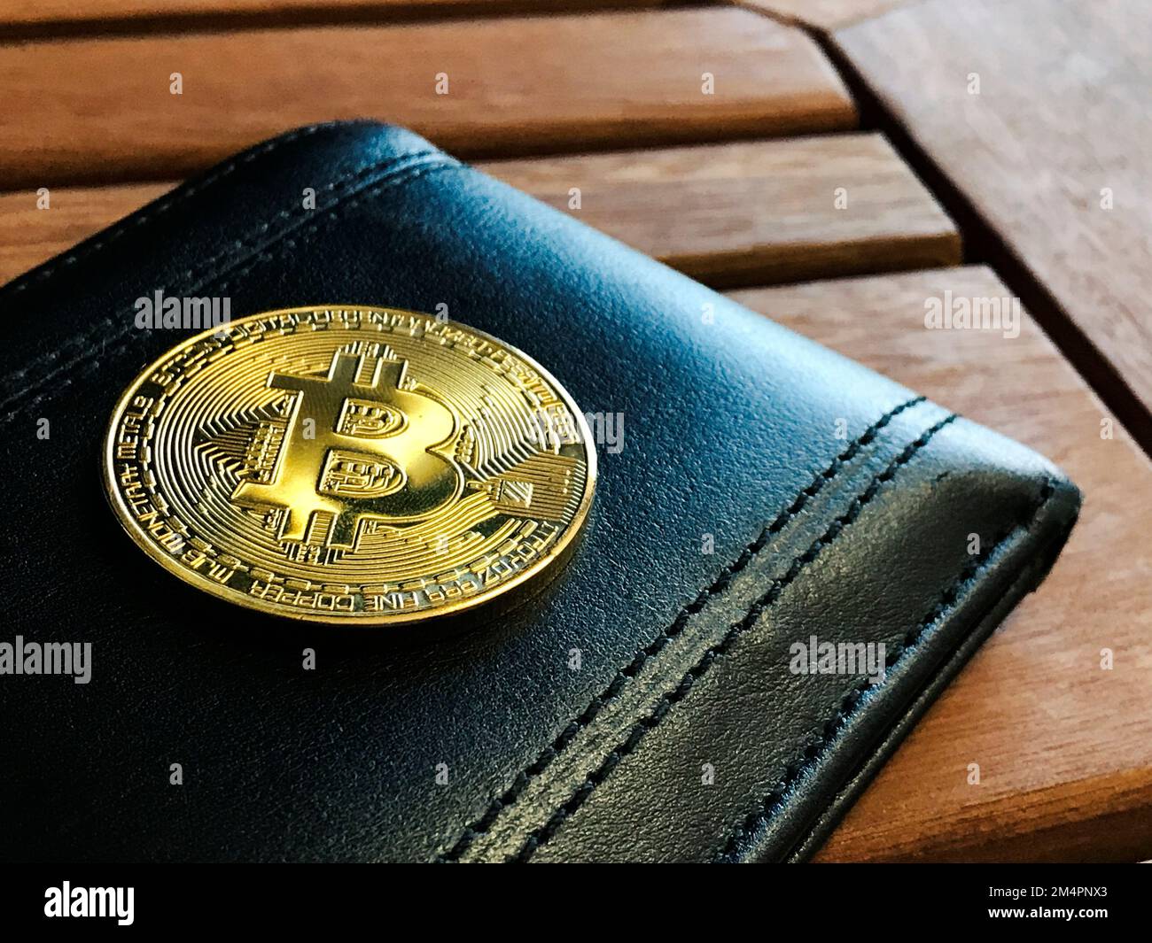 Bitcoin Gold Coin and Letter Wallet on Wooden Table. Space for text Stock  Photo - Alamy