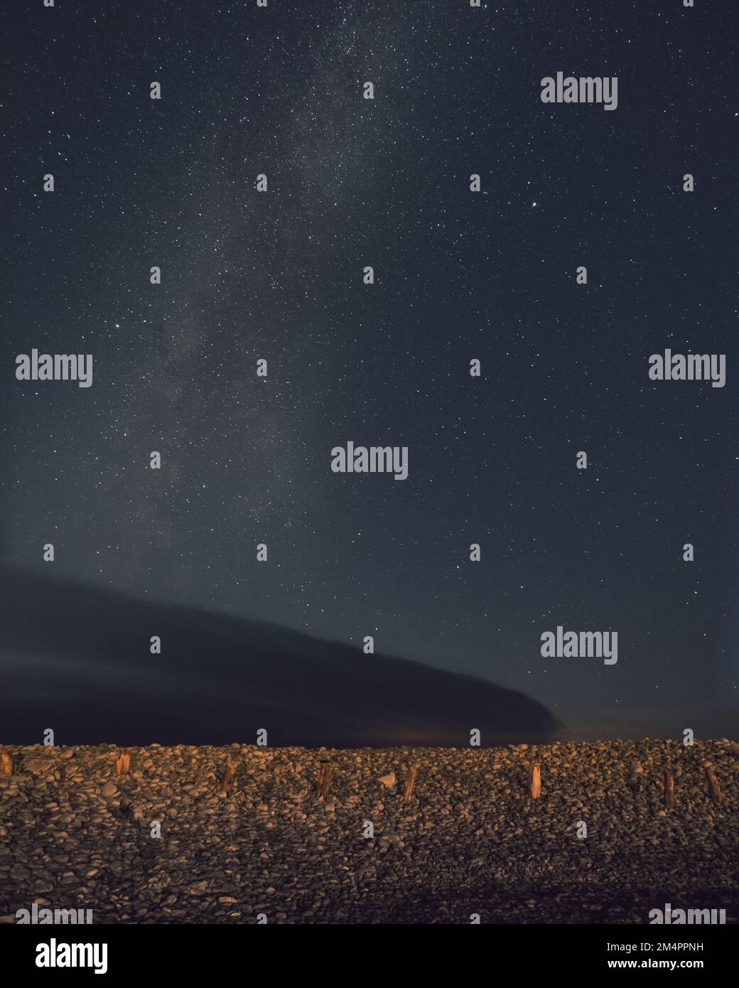 A vertical shot of the beautiful starry sky with the Milky Way above ...
