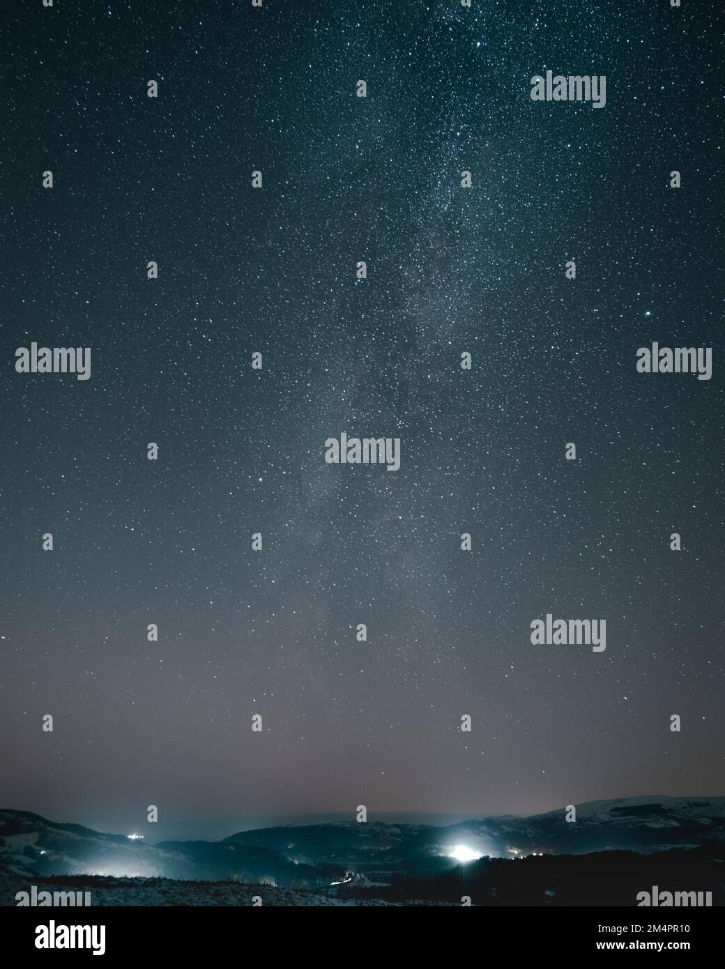 A vertical shot of the beautiful starry sky with the Milky Way above ...