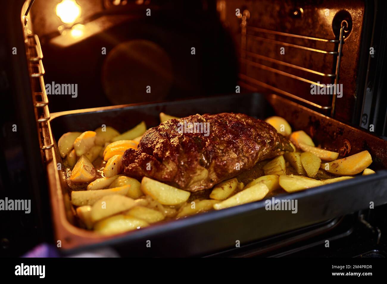 Cooking homemade food in an electric oven. Vegetable stew with potatoes