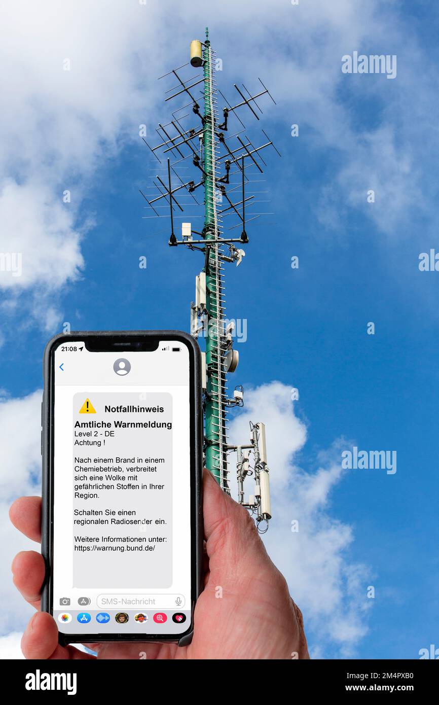 Symbolic image Cell broadcast, warning service via mobile phone, by SMS, to all devices located in the area of radio cells, transmission masts, which Stock Photo
