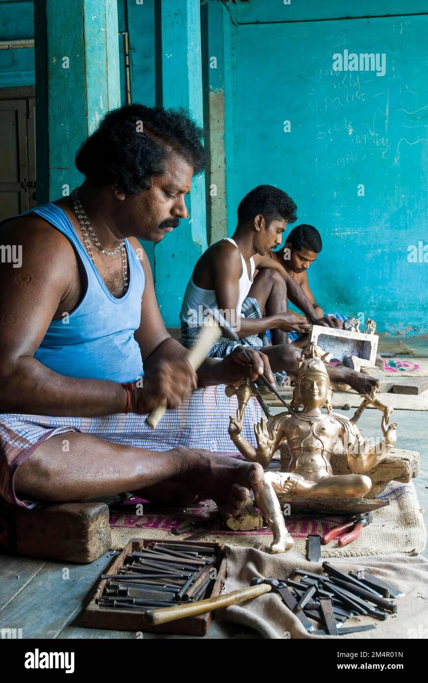 Artisans Chiselling bronze sculpture statue at Swamimalai, Tamil Nadu