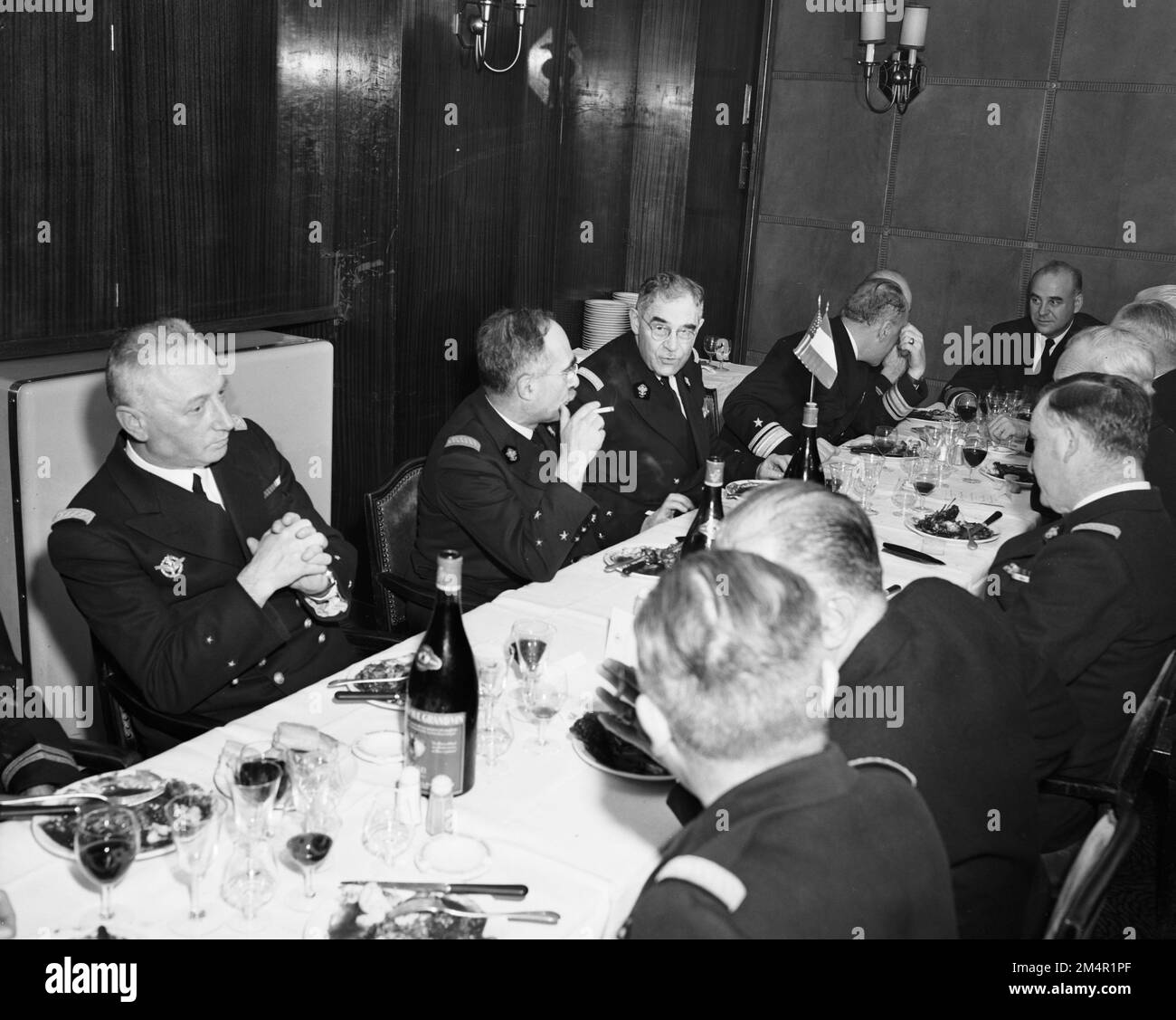 French and U.S. Navy Officials Meet Over Luncheon in Paris. Photographs of Marshall Plan Programs, Exhibits, and Personnel Stock Photo