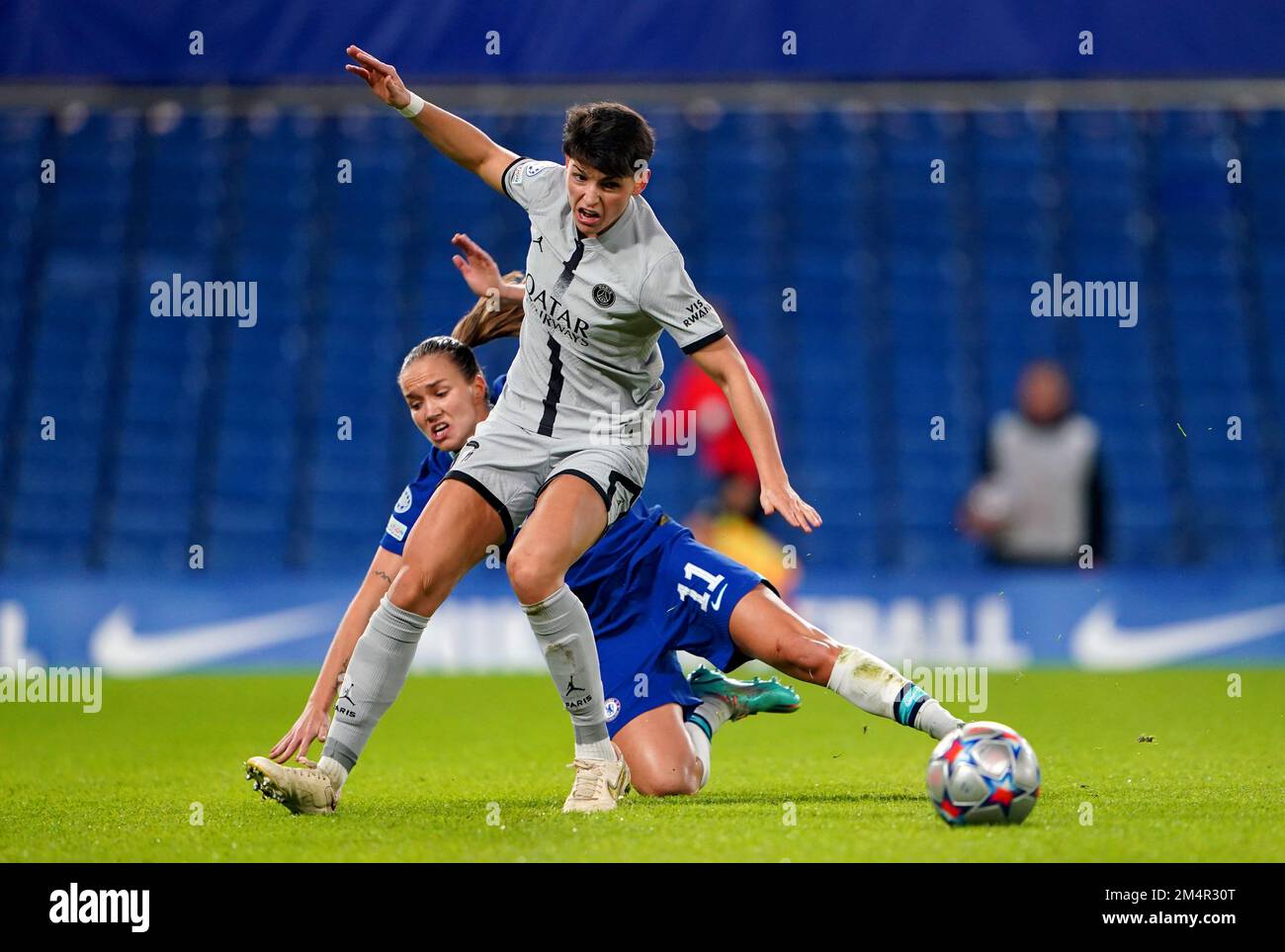 Chelsea's Guro Reiten goes down whilst battling for the ball against Paris Saint-Germain's Elisa de Almeida during the UEFA Women's Champions League Group A match at Stamford Bridge, London. Picture date: Thursday December 22, 2022. Stock Photo
