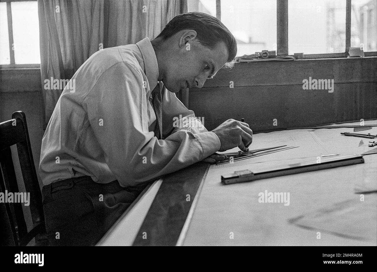 A aircraft designer at he's drawing table Stock Photo