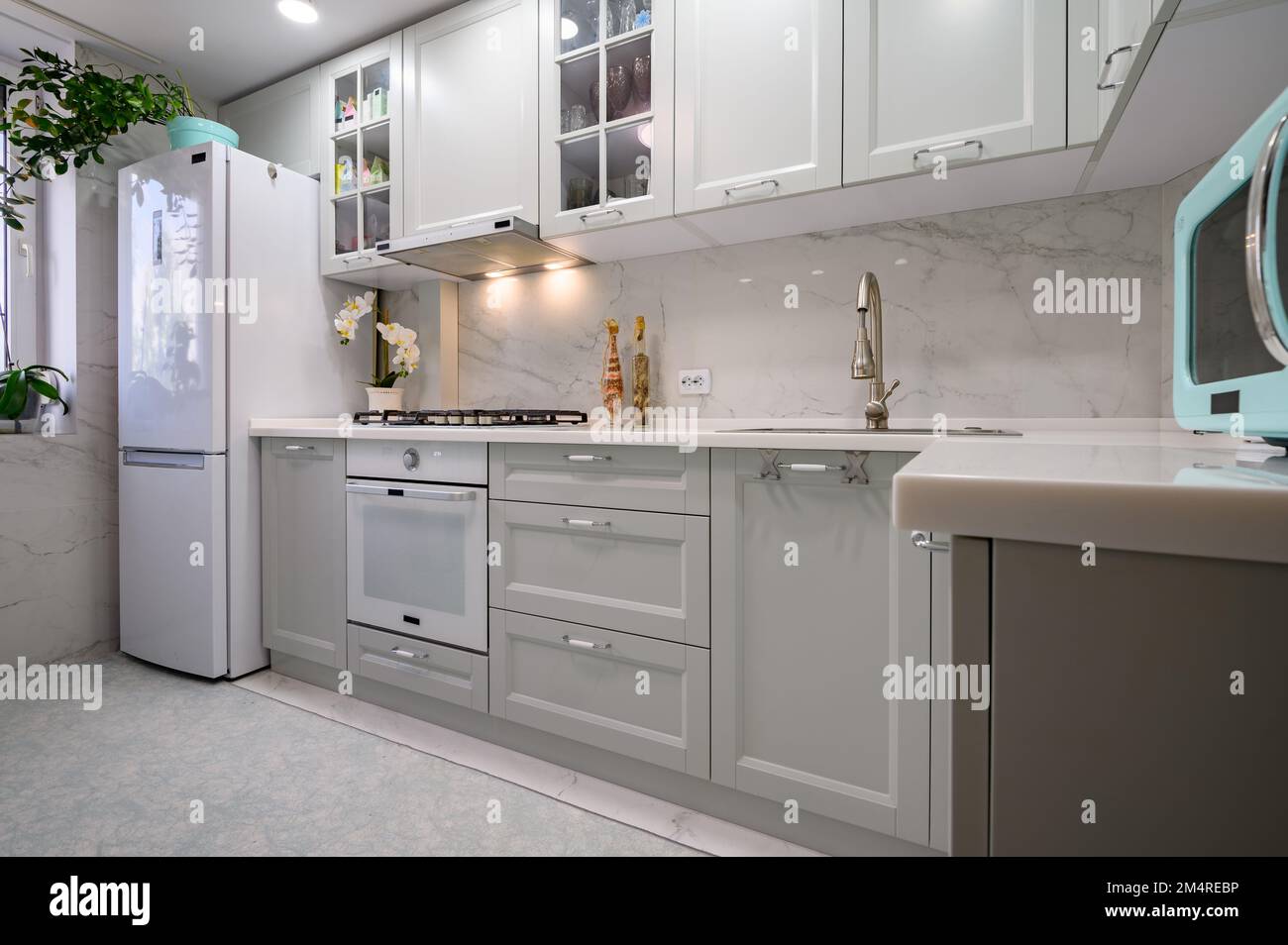 New light grey modern well designed kitchen interior Stock Photo - Alamy