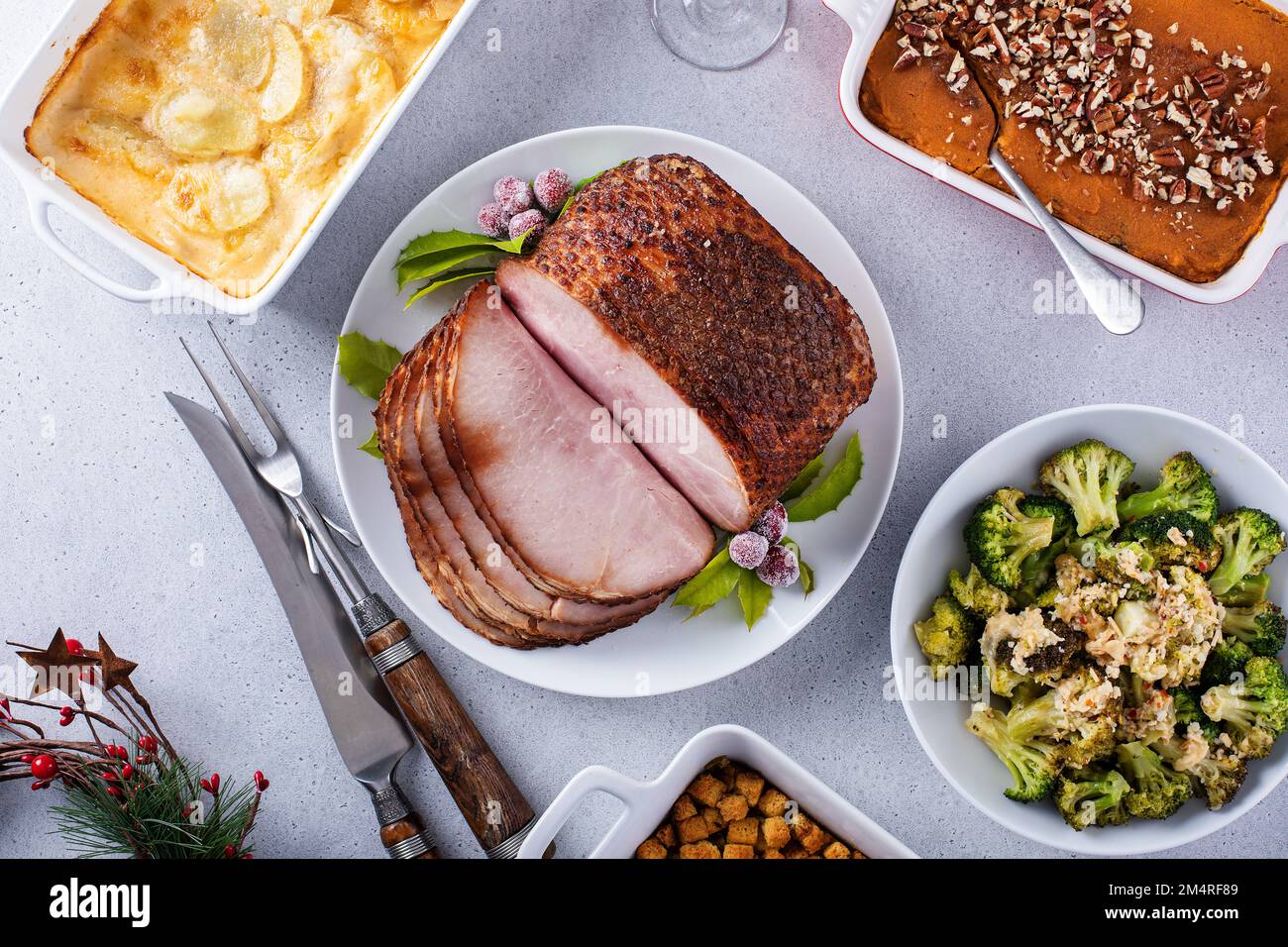 Christmas dinner with honey spiral sliced ham and side dishes Stock