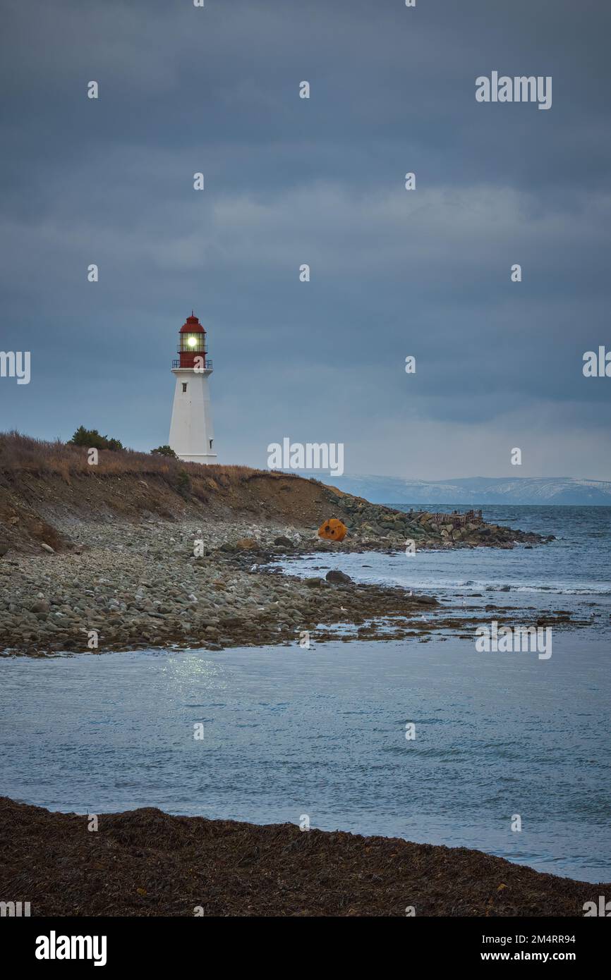The Low Point Lighthouse is at the entrance to Sydney Harbour near New Victoria Cape Breton Island Nova Scotia. Stock Photo