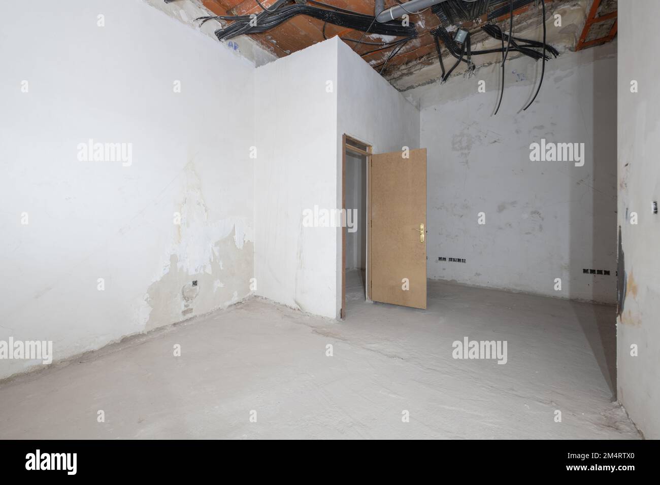 Rough premises with all exposed unfinished electrical piping and cement