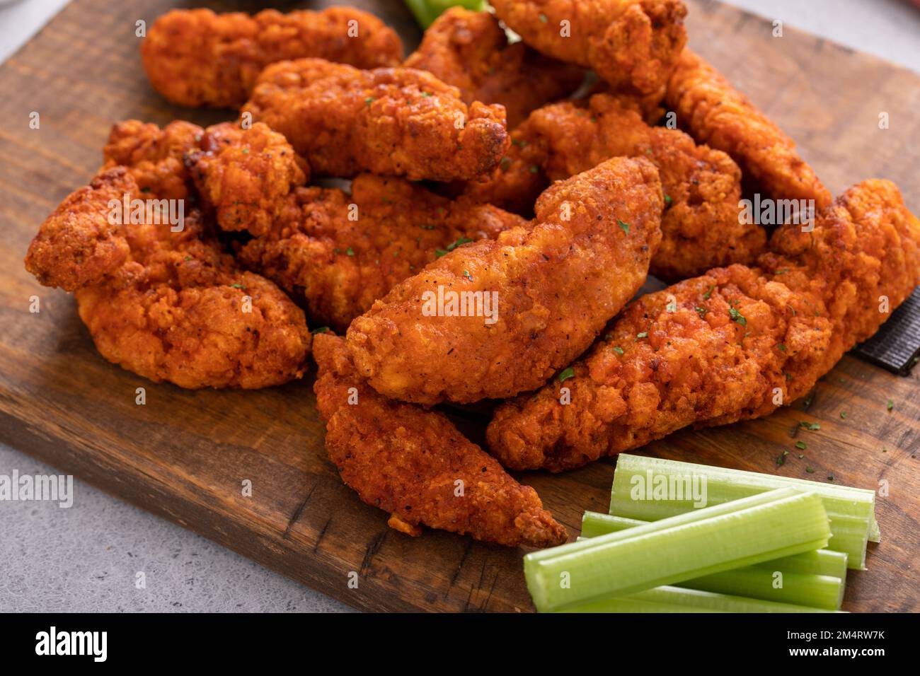 Buffalo chicken fingers served with ranch sauce and celery Stock Photo