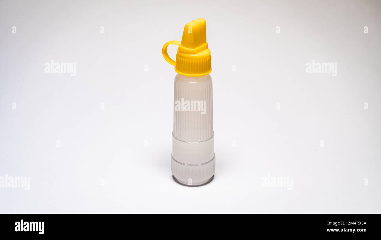Clear paper glue with a yellow cover isolated on a white background. Item model photo. Bright photo Stock Photo
