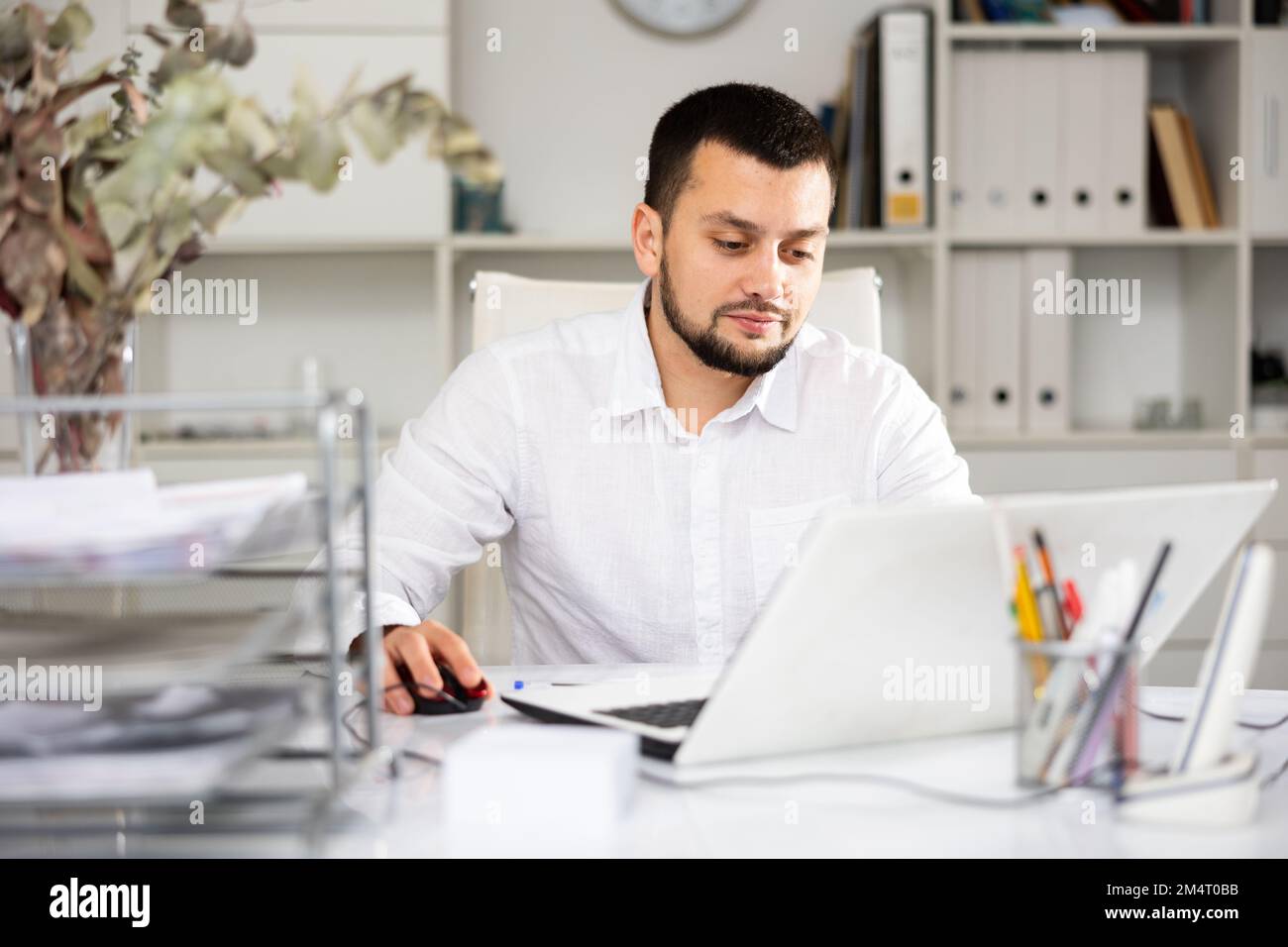 Male office manager using laptop computer Stock Photo