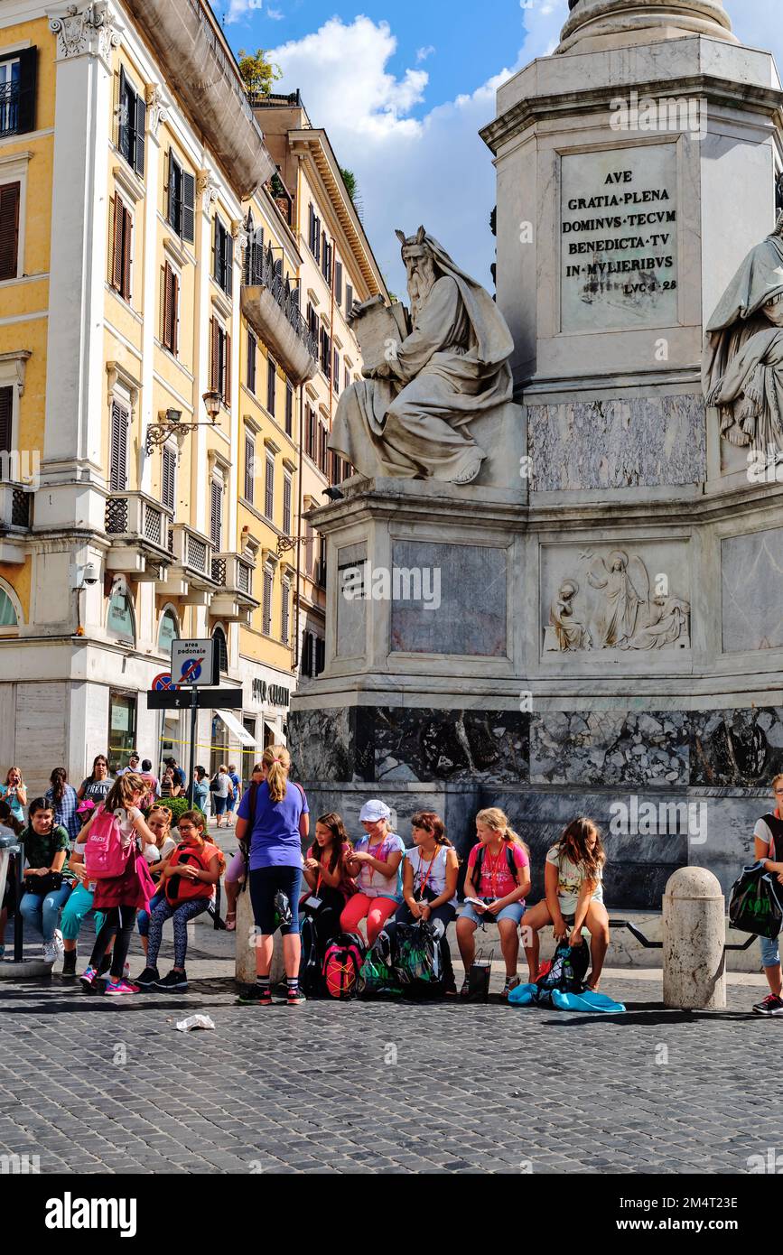 Tourists resting near monument Column of the Immaculate Conception, Rome Stock Photo