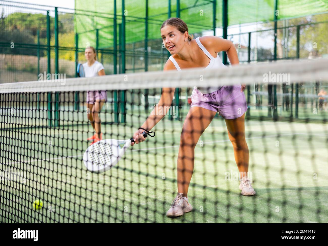 Young woman padel tennis player trains on the outdoor court Stock Photo