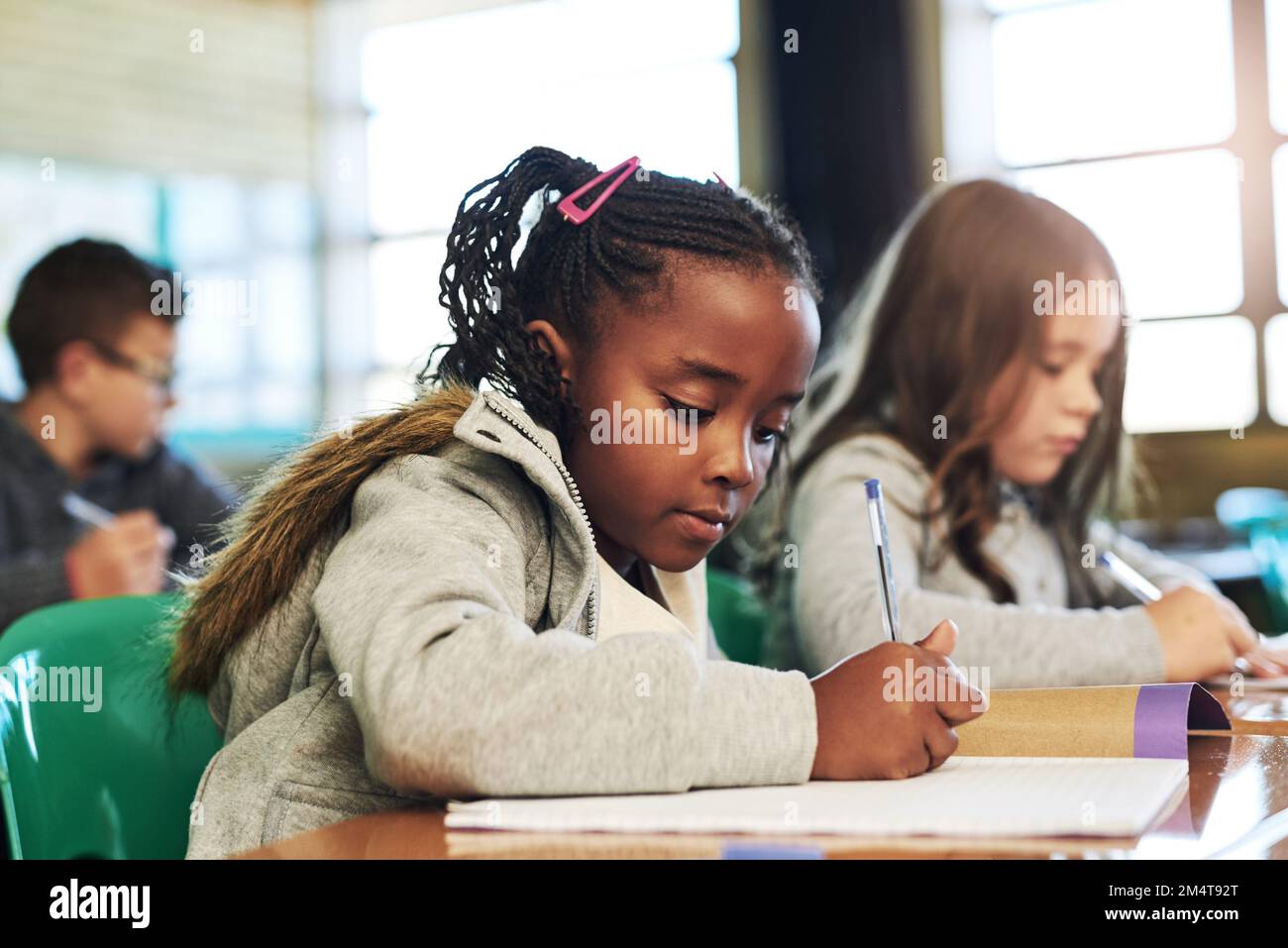 They get the best marks because they work the hardest. a group of elementary school children working in class. Stock Photo