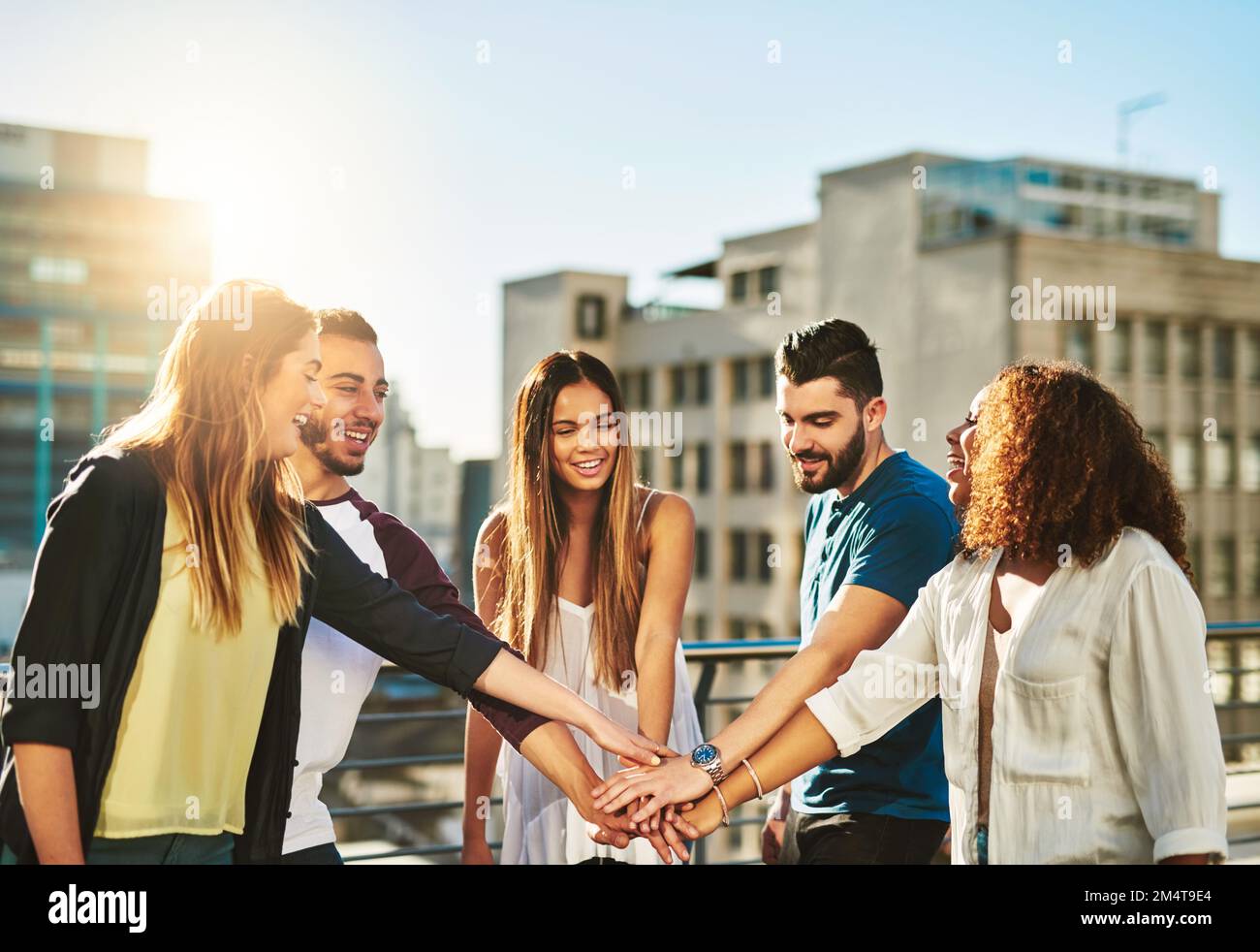 There is no I in team. a group of young people putting their hands ...