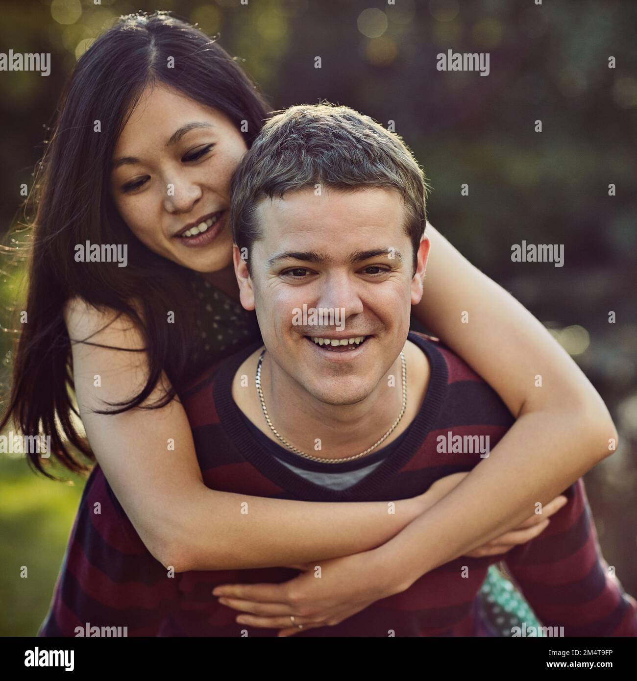 Happy diverse couple playing piggyback hi-res stock photography and ...