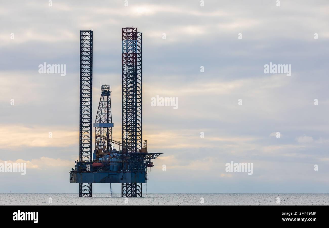 Oil platform in the sea at sunset Stock Photo