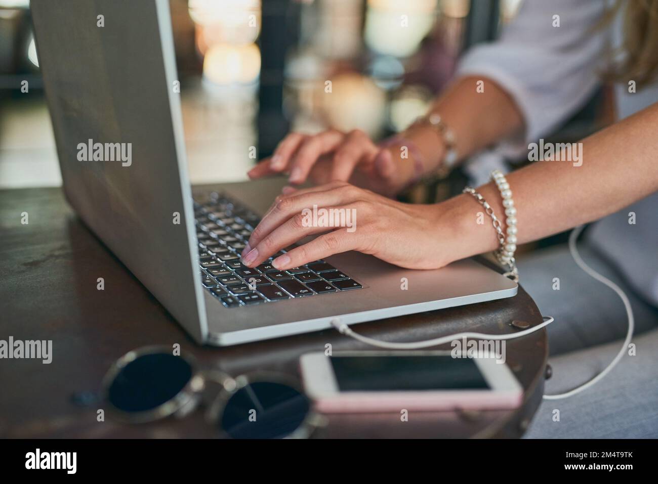 Getting into the blogging zone. an unrecognizable young woman using her laptop while sitting in a cafe. Stock Photo