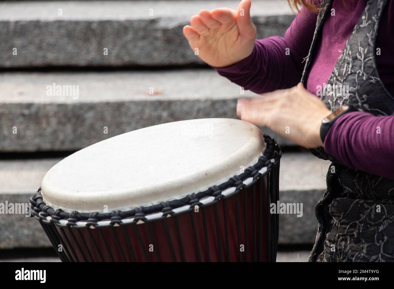 playing the drum with hands closeup, musical instrument Stock Photo