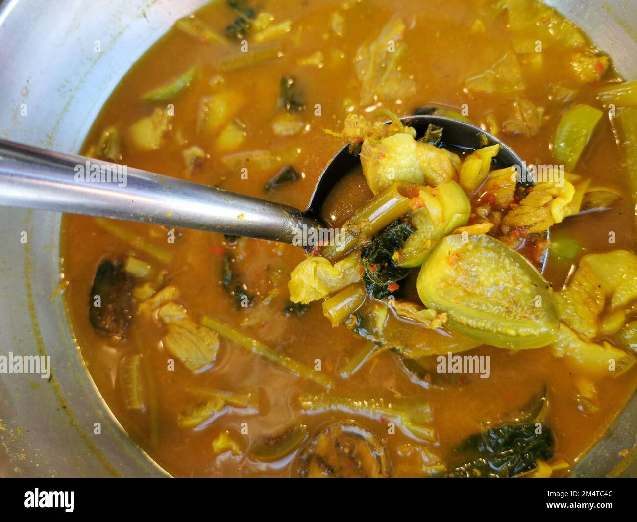 Southern Thai style Kaeng Som. A spicy and sour curry food in a bowl. Traditional cuisine in Phuket, Thailand. Stock Photo