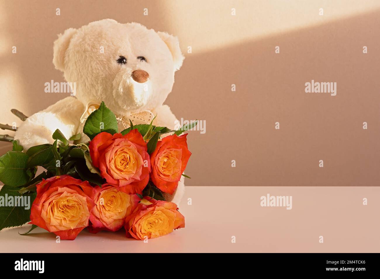 Rose's teddy bear. The concept of festive mood, recognition of feelings and love. Birthday gift, Baby's Birthday, Valentine's Day, Wedding Day. Bright Stock Photo
