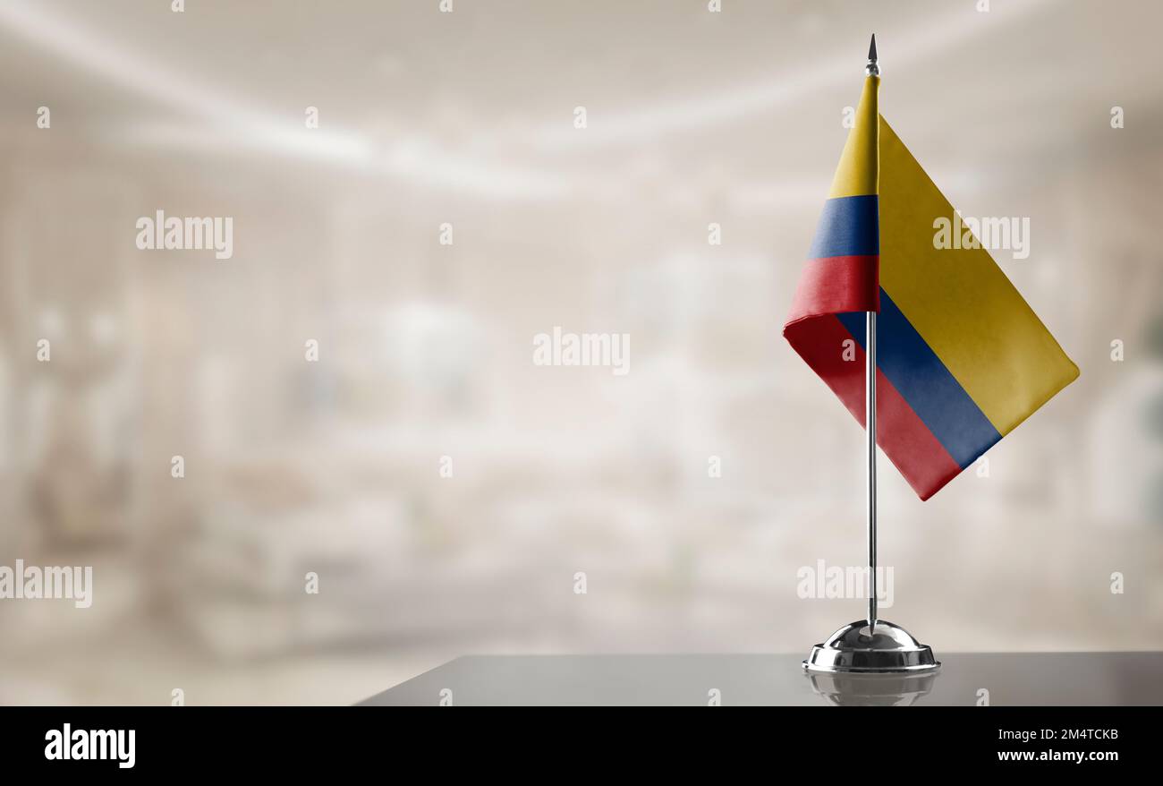 A small Colombia flag on an abstract blurry background. Stock Photo