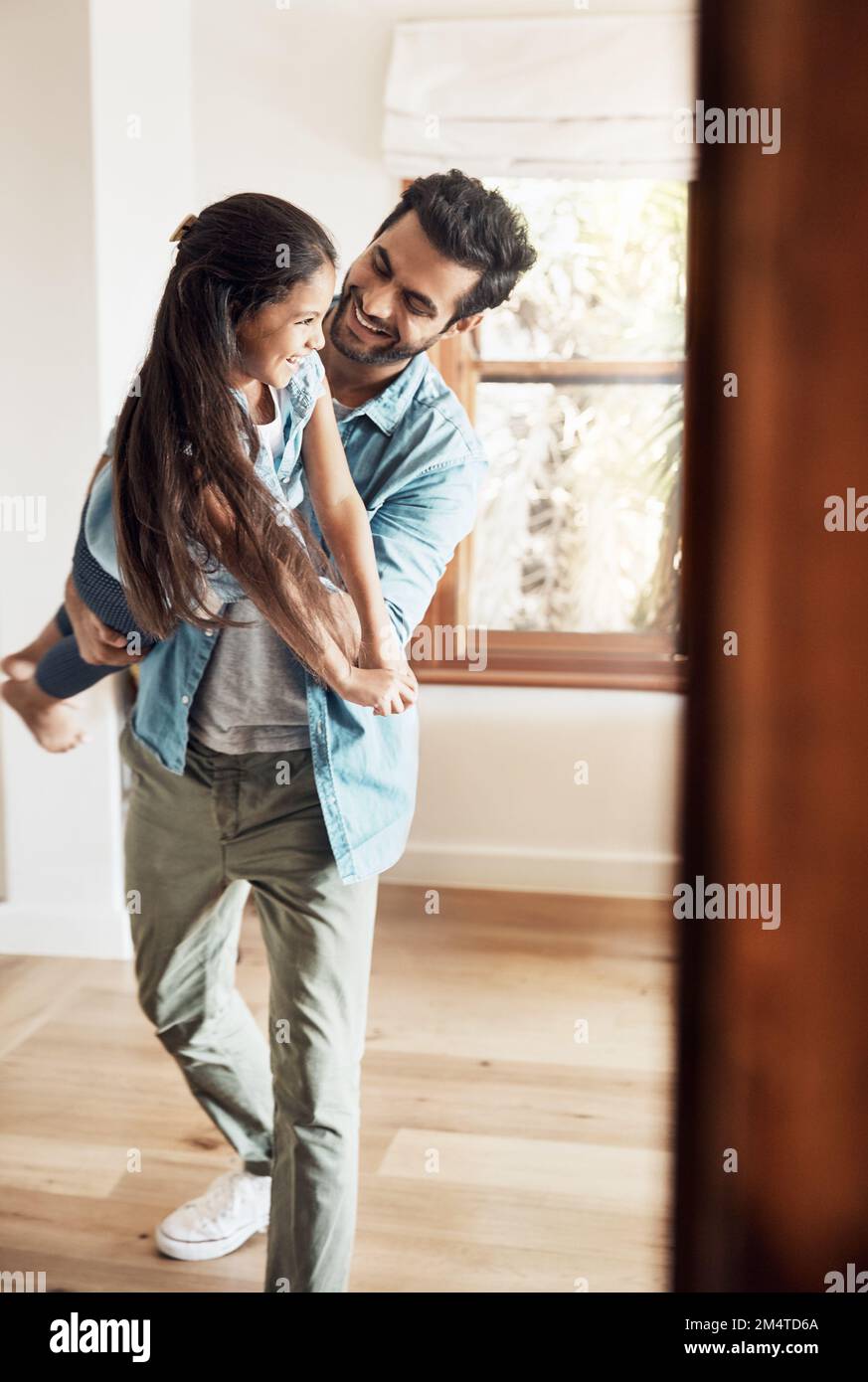 Fun times with a fun dad. a happy father and daughter playing together ...